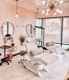 a salon with chairs, mirrors and lights in it's center area is shown