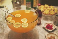 a glass bowl filled with liquid and lemon slices