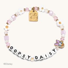 a white bracelet with pink and gold beads that says,'popsy daisy '