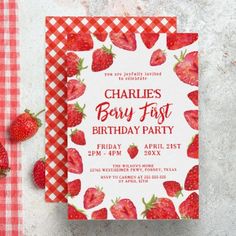 a red and white checkered table cloth with strawberries on it next to a card that says charles's berry fast birthday party