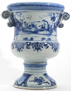 a blue and white vase sitting on top of a table