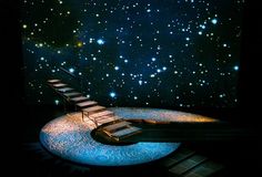 an artistic scene with stairs leading up to the stars