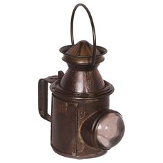 an old fashioned lantern with a light on it's side and a white background