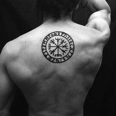 a man with a compass tattoo on his back