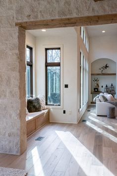 a living room filled with furniture and windows