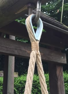 a rope hanging from the side of a wooden structure