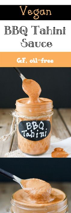 a jar filled with bbq tahini sauce on top of a wooden table next to a spoon