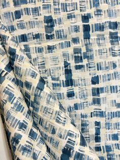 a blue and white fabric with squares on it