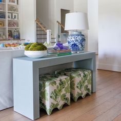 a blue and white vase sitting on top of a table