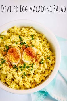 deviled egg macaroni salad in a white bowl with two boiled eggs on top