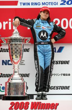 a man standing next to a trophy on top of a table