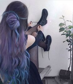 a woman with purple hair and black boots