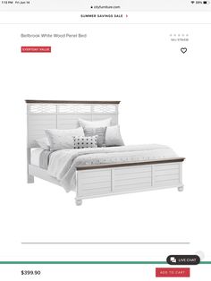 a bed with white wood frame and pillows on the bottom shelf in a storefront page