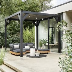 an outdoor living area with couches and tables