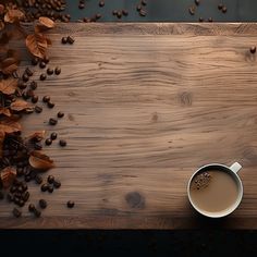 a cup of coffee sitting on top of a wooden table next to some coffee beans