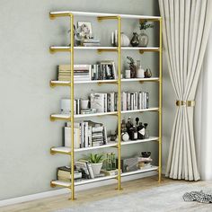 a white and gold book shelf with books on it next to a window in a living room