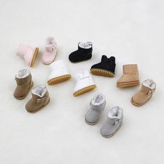 there are many different types of baby shoes on the white surface, including one for toddlers and one for older children