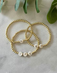 - 18k gold filled beaded initial bracelet with pearl initial beads. Perfect stacking bracelet to layer with other pieces. Great gift for mom to have children's initials, your boyfriends initials or just your own. Beaded on high quality stretch cord and secured. - 4mm 18k gold filled beads - Freshwater pearl letter beads - Choose up to 3 initials per bracelet, listing them in order in personalization box. If looking for more then 3 initials please send me a message. -Each purchase is sent in a dr Boyfriend Initials, Pearl Letters, Monogram Bracelet, Bracelet Initial, Bracelets Design, Bracelet Pearl, Custom Bracelet, Beads Bracelet Design, Gold Bead Bracelets