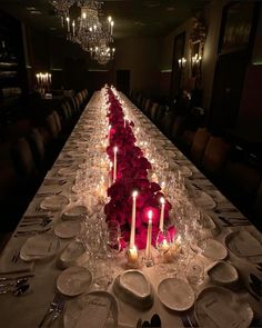 a long table is set up with candles and plates for an elegant dinnereon party