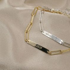 Our personalized paperclip ID bar bracelet is available in 14k gold filled or sterling silver. Engrave it with a name, special date or initials. We love the minimalist look and dainty vibe. The sturdy paperclip chain is perfect for everyday wear. Adjustable and easy to find the perfect fit with the built-in extender. Can be worn 6 to 8 inches long. (custom sizes available too, just ask!) 100% gold filled or sterling silver, so this sweet piece won't tarnish or turn. Wear it 24/7!DETAILS: 14kt go Custom Engraved Bracelet, Bar Bracelet, Id Bracelets, Engraved Bracelet, Bar Bracelets, Engraved Jewelry, 14kt Gold, Paper Clip, Custom Engraving