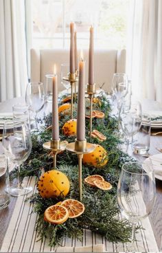 a table with candles and oranges on it