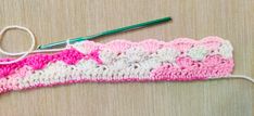 a crochet hook is hooked up to a piece of yarn that has been stitched together