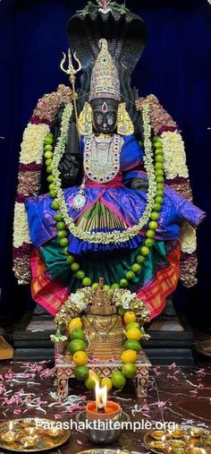 the statue is decorated with fruits and decorations