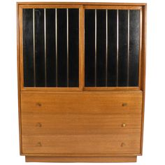 an old wooden cabinet with glass doors on the front and bottom drawers, against a white background