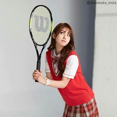 a woman holding a tennis racquet in her hand