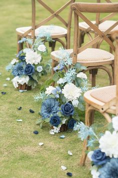 the chairs are lined up with blue and white flowers on them for an outdoor ceremony