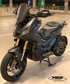 a black motorcycle parked in a parking lot