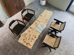 an aerial view of a table with chairs and a piece of wood on the table