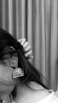 black and white photograph of a woman brushing her hair