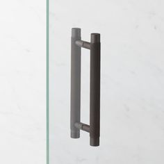 an image of a door handle that is on the side of a glass wall with marble background