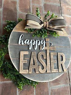 a sign that says happy easter hanging on the side of a brick wall with greenery around it