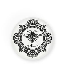 a black and white plate with a bee on it