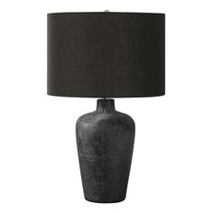 a gray table lamp with a black shade on it's base and a dark fabric lampshade