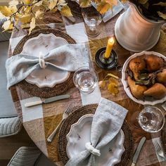 the table is set with dishes and silverware