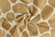 a giraffe print fabric is shown in brown and white