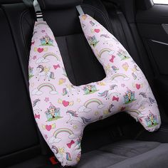 a seat cushion with unicorns and rainbows on it in the back of a car