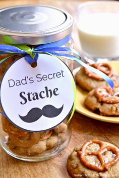 a jar filled with cookies sitting on top of a wooden table next to other cookies