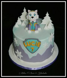 a frosted cake with a wolf on top and snowflakes around the edges