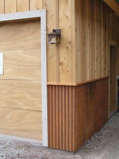 a wooden garage with an open door on the side