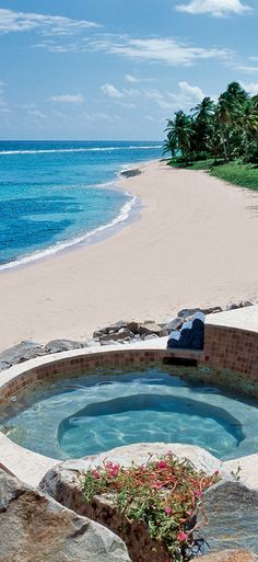 a hot tub sitting on top of a sandy beach