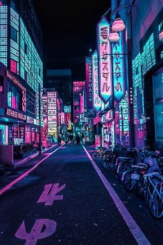 a city street at night with neon lights