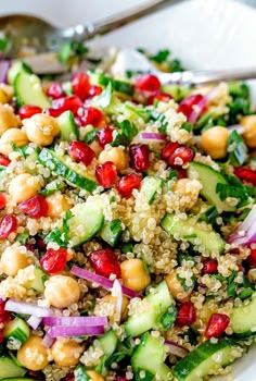 a salad with cucumber, red onion, and chickpeas in it