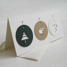 three cards with different designs on them, one has a christmas tree and the other is a deer