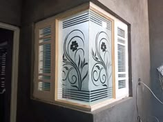 a decorative window in the corner of a room