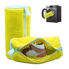 a pair of tennis shoes sitting in a yellow shoe bag next to a dryer