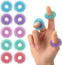 a hand is pointing to several different colored hair clips